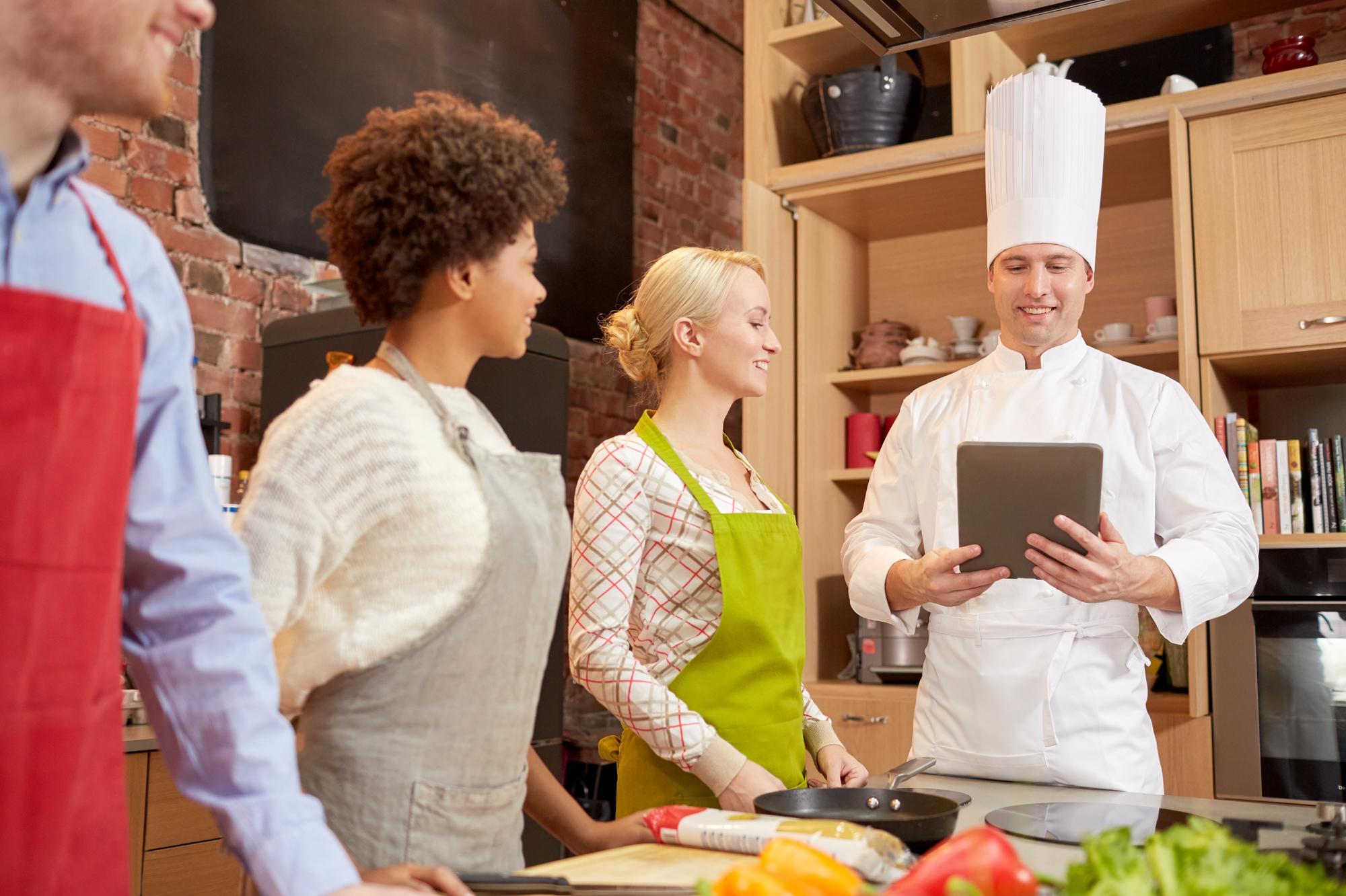 Instructor talking to a small group in kitchen