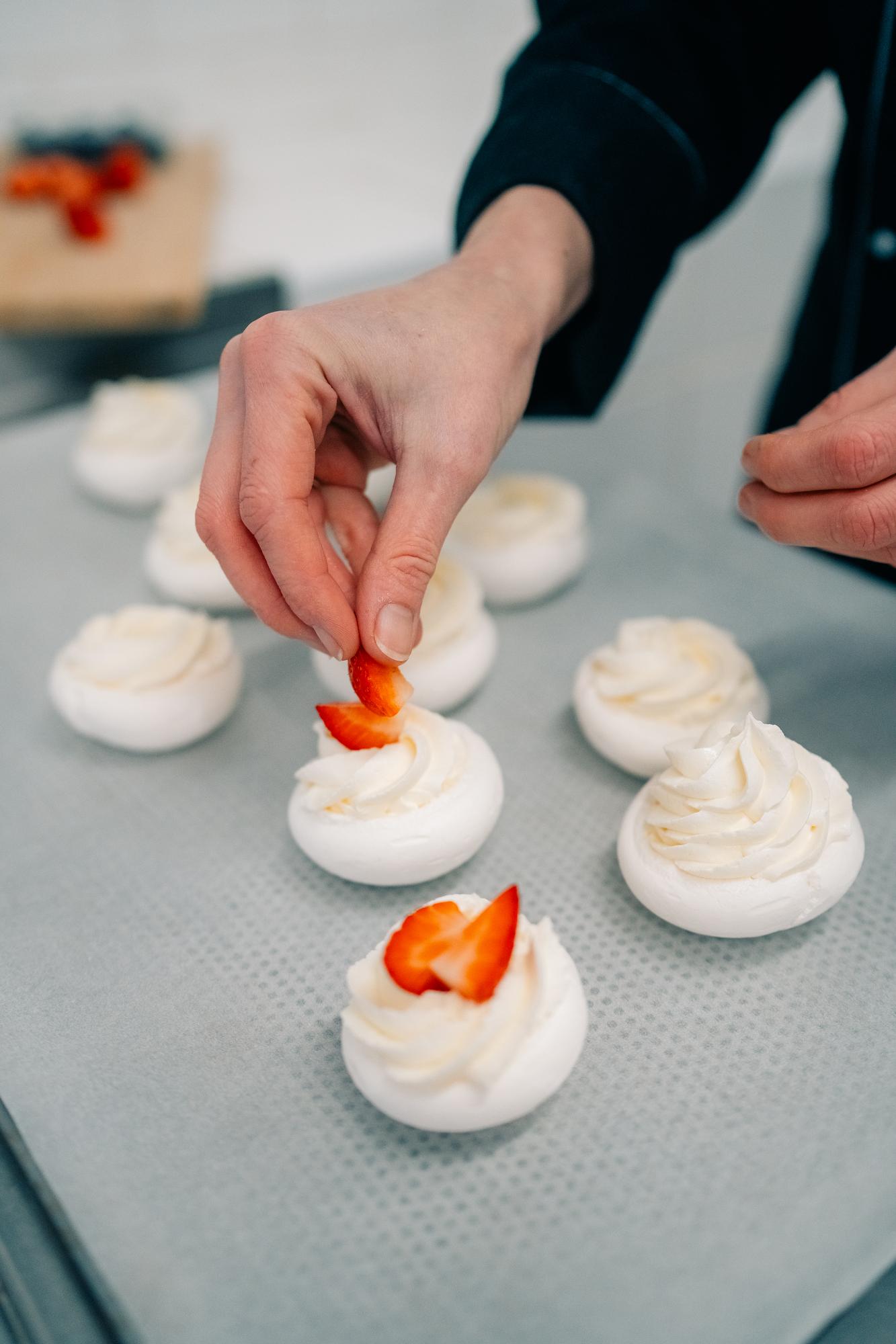 Two students plating desserts